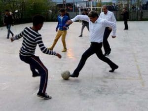 Davudoghlu playing a football with child