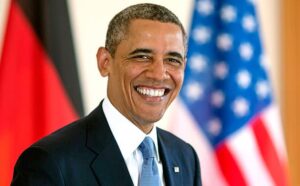 BERLIN, GERMANY - JUNE 19:  U.S. President Barack Obama smiles as he signs the official guest book at Bellevue Palace on June 19, 2013 in Berlin, Germany. U.S. President Barack Obama is visiting Berlin for the first time during his presidency and his speech at the Brandenburg Gate is to be the highlight. Obama will be speaking close to the 50th anniversary of the historic speech by then U.S. President John F. Kennedy in Berlin in 1963.   (Photo by Thomas Imo/Photothek via Getty Images)