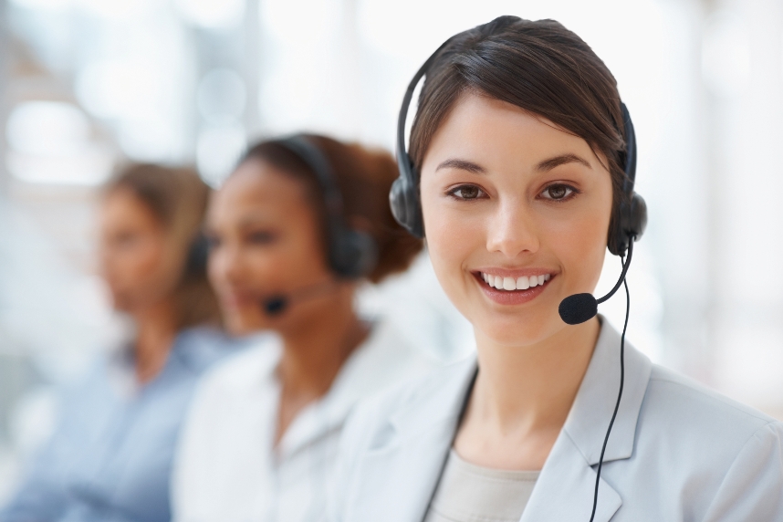 Closeup of a call center employee with headset at workplace
